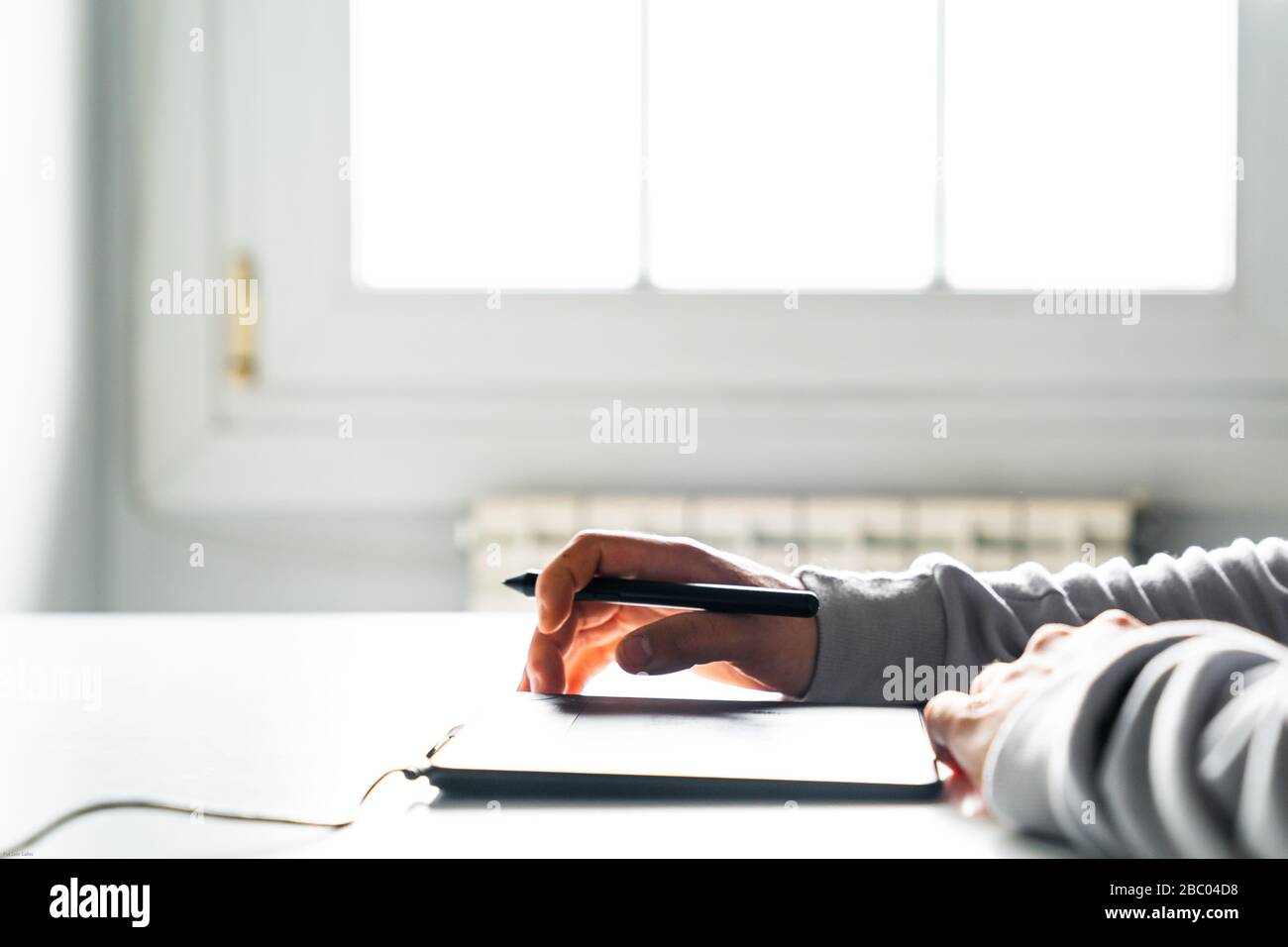 Young man designer using a stylus and graphics table Stock Photo
