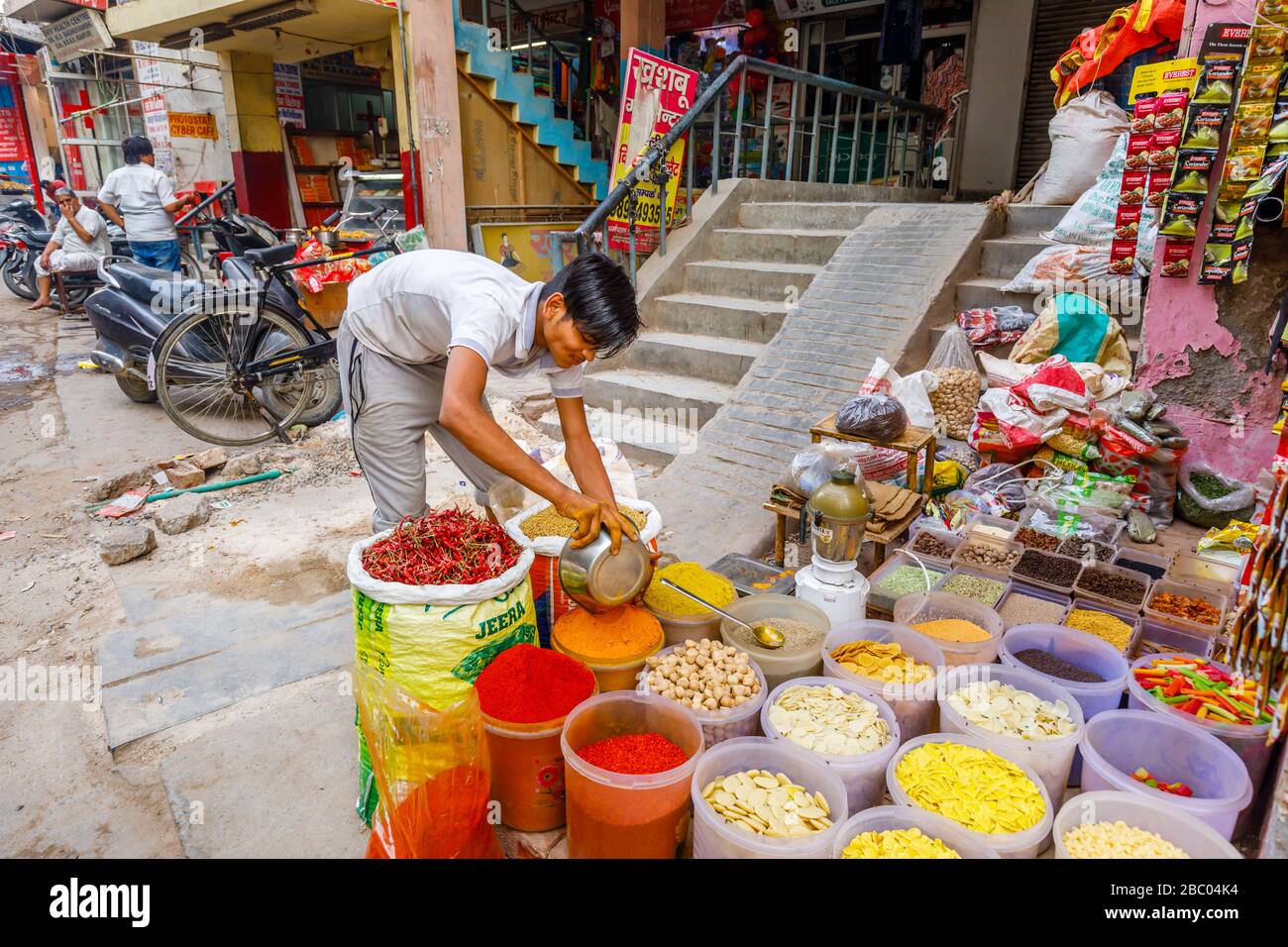 Colourful spices and dried vegetables on display: street scene in Mahipalpur district, a suburb near Delhi Airport in New Delhi, capital city of India Stock Photo