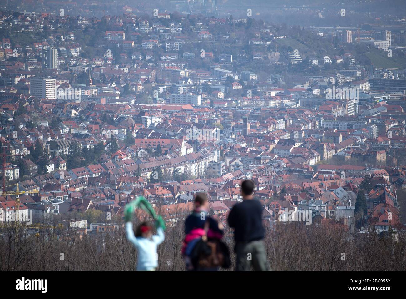 Stuttgart, Germany. 02nd Apr, 2020. People stand on the Birkenkopf and look at the view of the city centre. More than 15,000,000 cubic metres of rubble were deposited on the hill after the Second World War. The mountain is popularly known as 'Monte Scherbelino'. Credit: Marijan Murat/dpa/Alamy Live News Stock Photo
