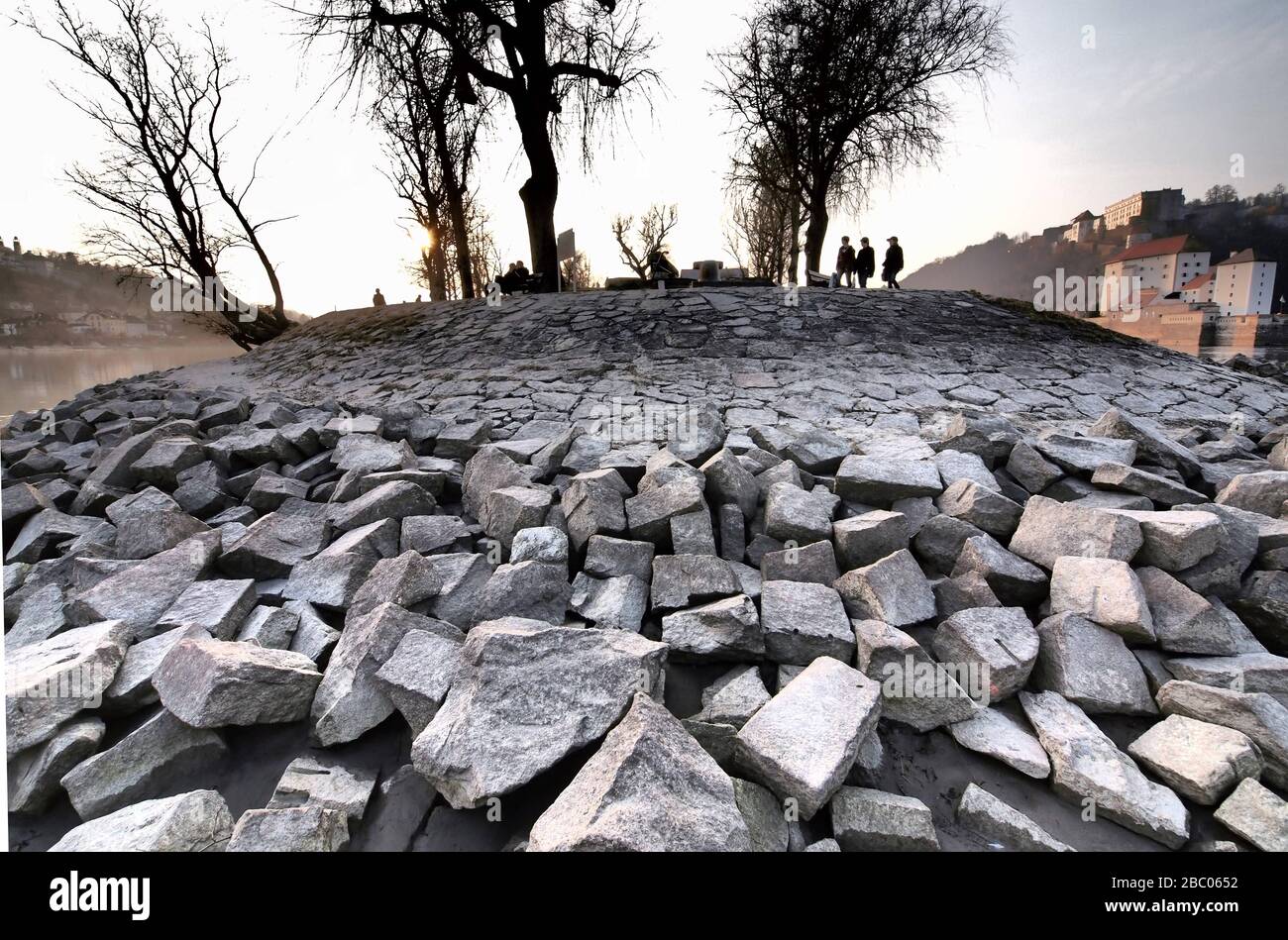 Stones of the bank reinforcement at low water at the confluence of the Inn and Danube in Passau. [automated translation] Stock Photo