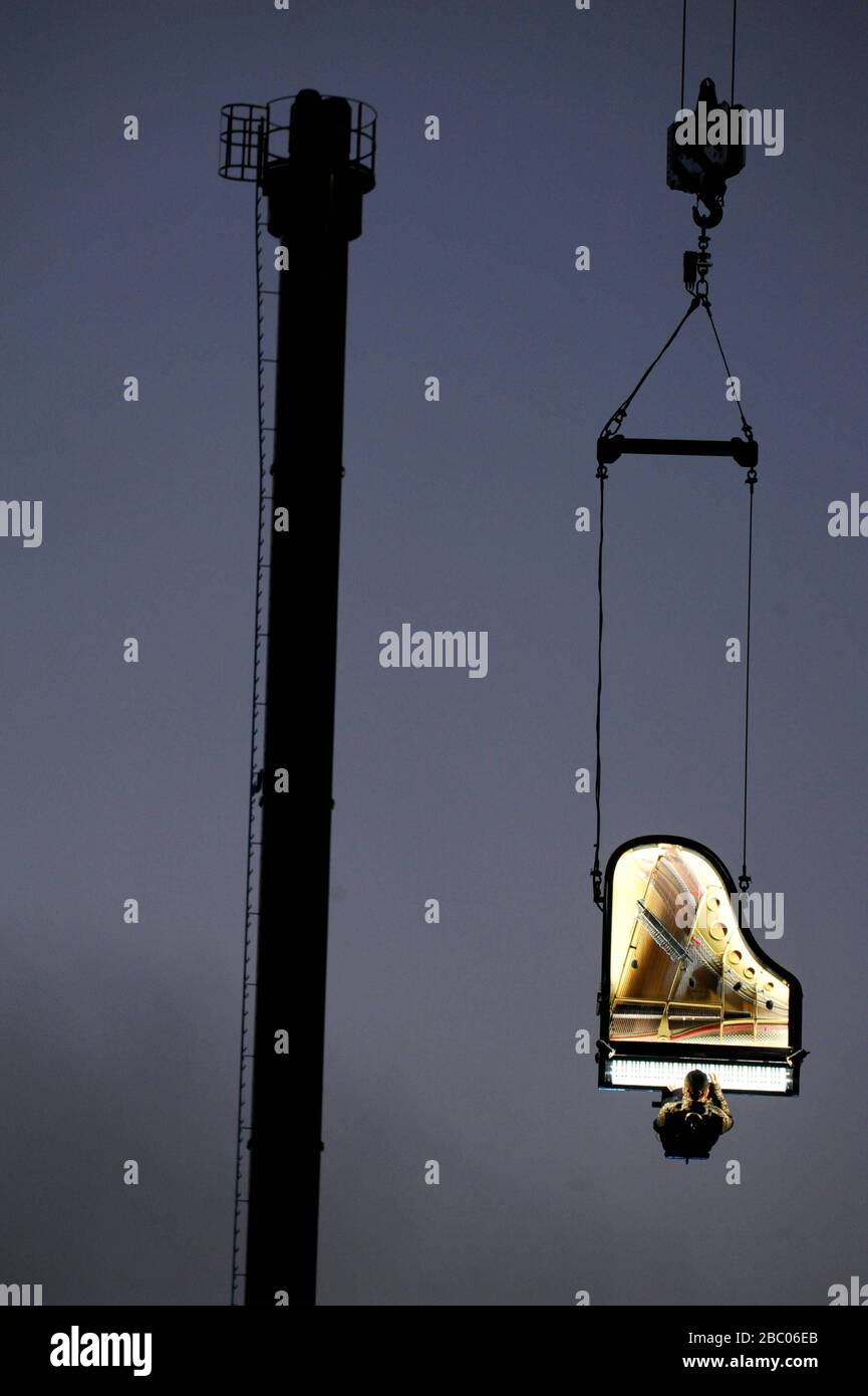 Piano Vertical" by Alain Roche: At 6:45 in the morning, pianist Alain Roche,  suspended from a crane, gives a concert in the factory district above the  construction site of the new concert
