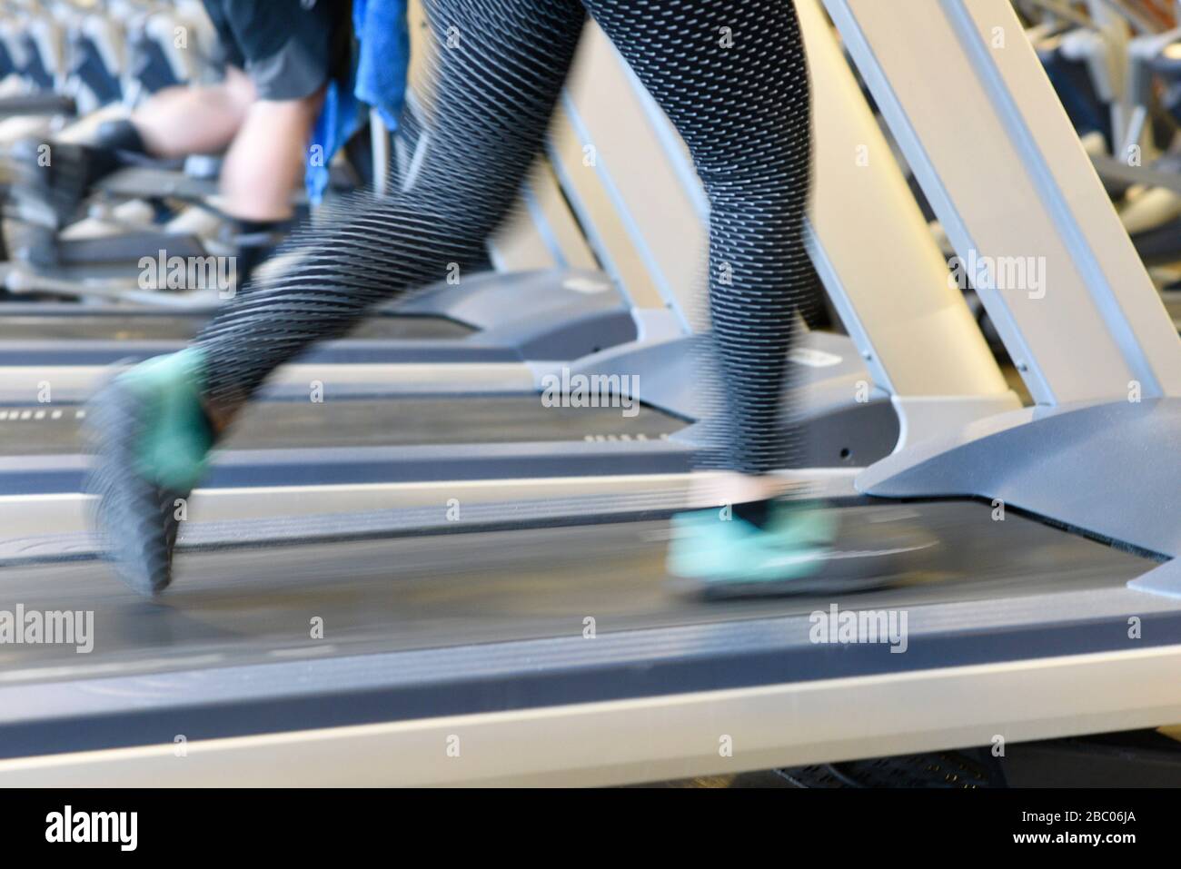 A woman is running on a treadmill in a gym in Munich. [automated translation] Stock Photo