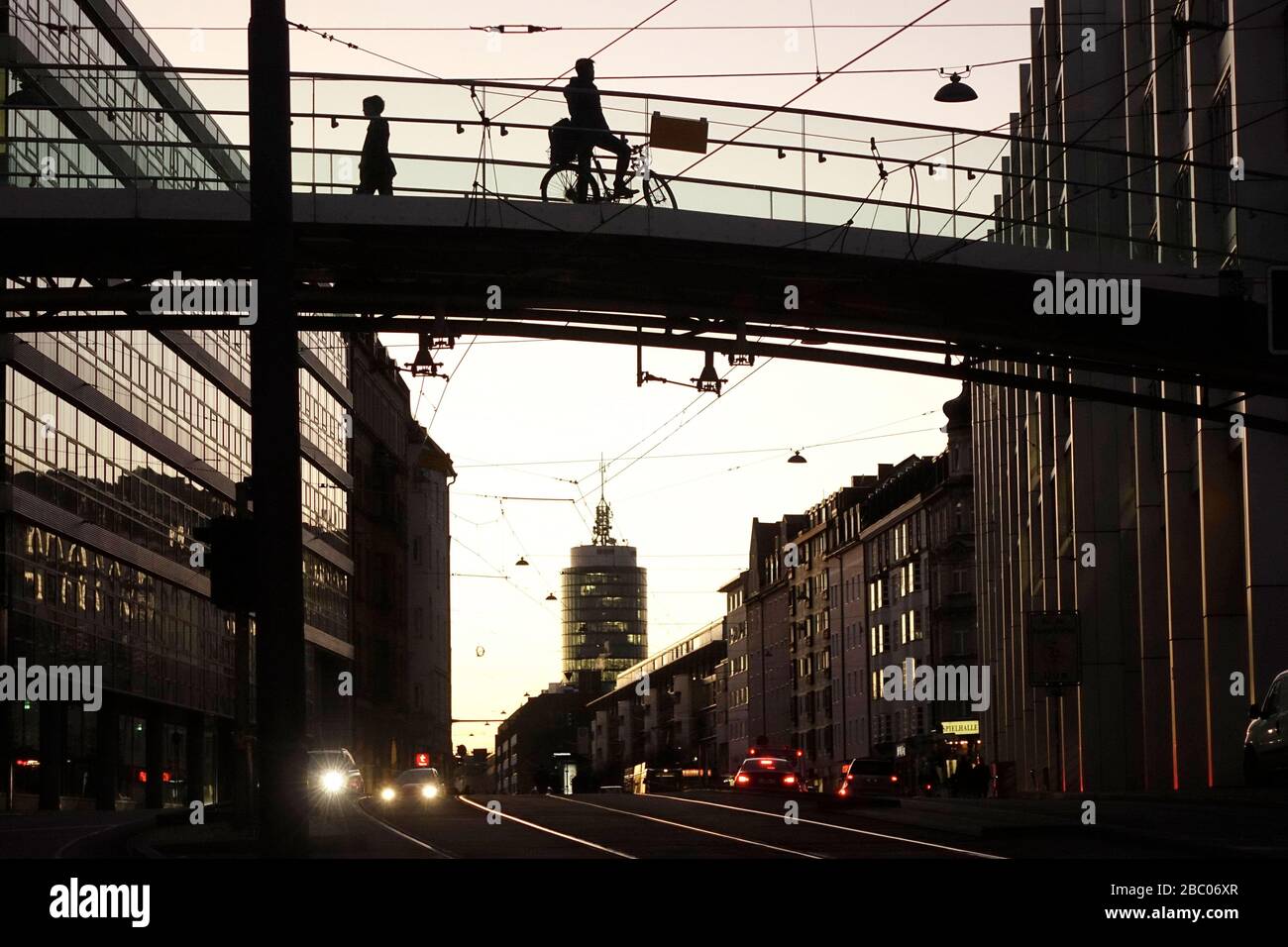 The pedestrian and cyclist bridge over Landsberger Straße at the level of the European Patent Office, photographed in the light of the setting evening sun. In the background the Central Tower. [automated translation] Stock Photo