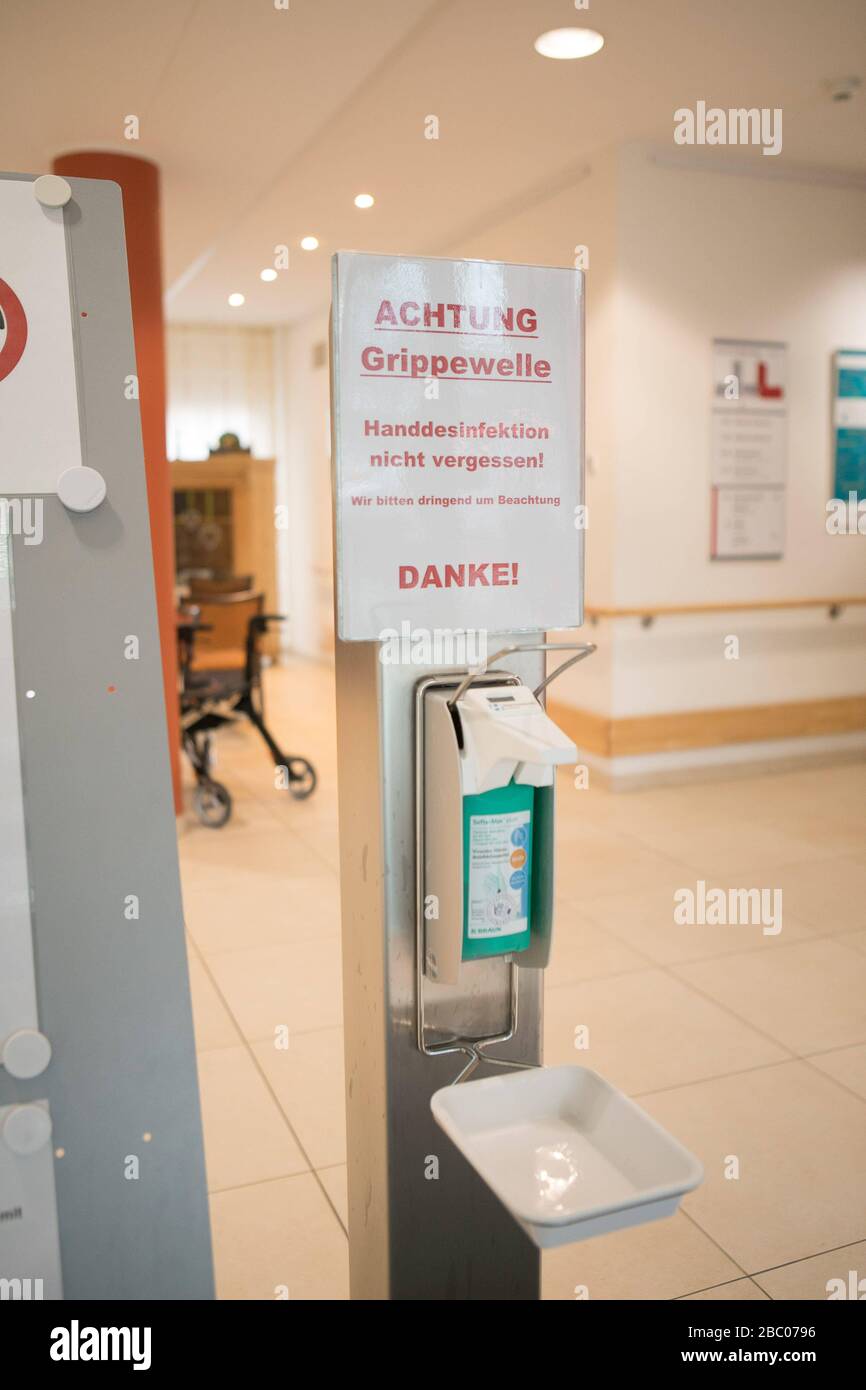 Disinfectants and tightened hygiene measures to protect against the corona virus and other pathogens (such as influenza) in the old people's home of the municipal Munich Abbey on Effnerstrasse. The picture shows signs in the entrance area with the request for hand disinfection and to avoid shaking hands for greeting. [automated translation] Stock Photo