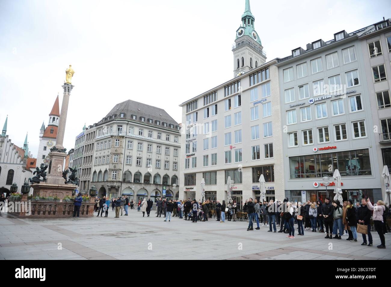 Effects of the corona virus: on Munich's Marienplatz in front of the city hall there are significantly fewer people than usual. [automated translation] Stock Photo