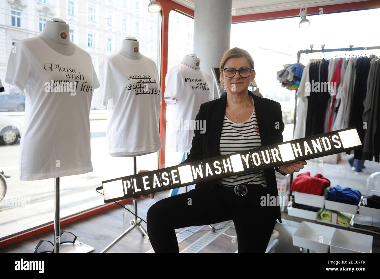 The T-shirt shop and design office at Einstein 102 has T-shirts with the slogan 'Corona Please wash your hands' in its shop window. In the picture owner Sibylla Meckel. [automated translation] Stock Photo