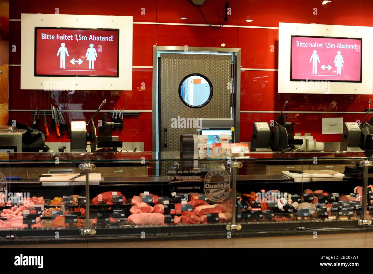 Food shopping in times of the Corona pandemic: in the picture, signs in the meat and sausage department of a branch of the Rewe supermarket chain in Obergiesing call on customers to keep their distance. [automated translation] Stock Photo