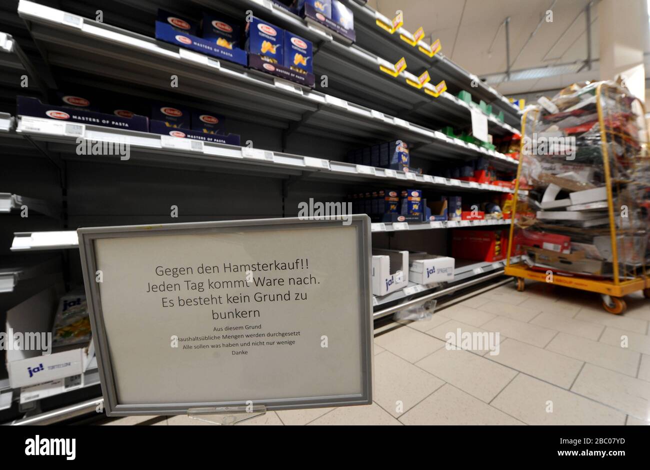 Food shopping in times of the Corona pandemic: in the picture empty shelves of toilet paper and pasta in a branch of the supermarket chain Rewe in Obergiesing. Signs warn against unnecessary hamster purchases, as regular replenishment is guaranteed. [automated translation] Stock Photo