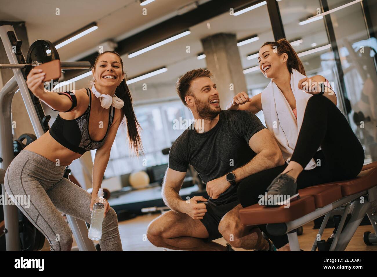 Group of sportive people in a gym taking selfie. Concepts about