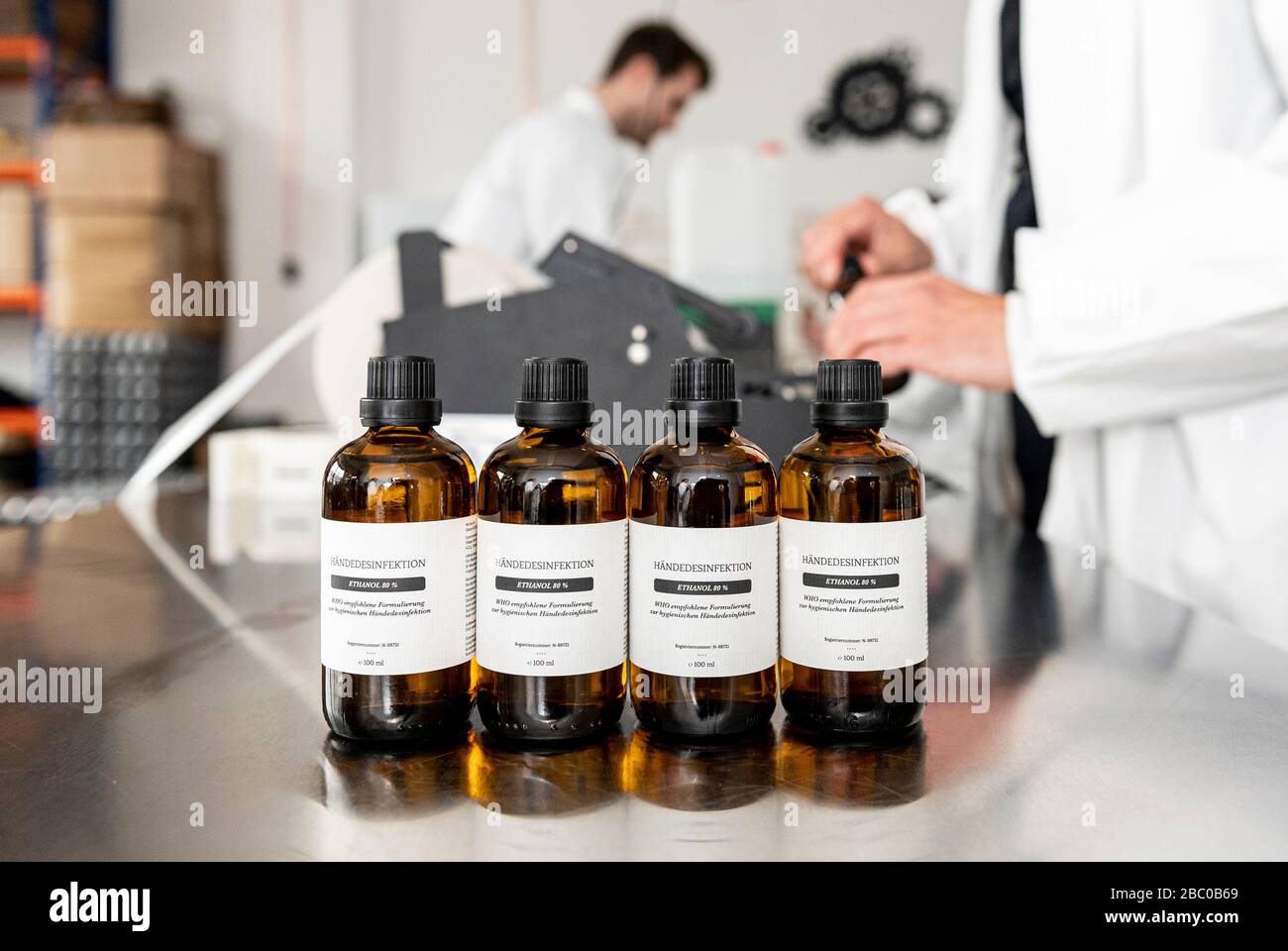 Berlin, Germany. 30th Mar, 2020. On a table in the Deutsche Spirituosen Manufaktur are bottles of hand disinfectant. The Deutsche Spirituosen Manufaktur now produces disinfectants because of the coronavirus. Credit: Fabian Sommer/dpa/Alamy Live News Stock Photo