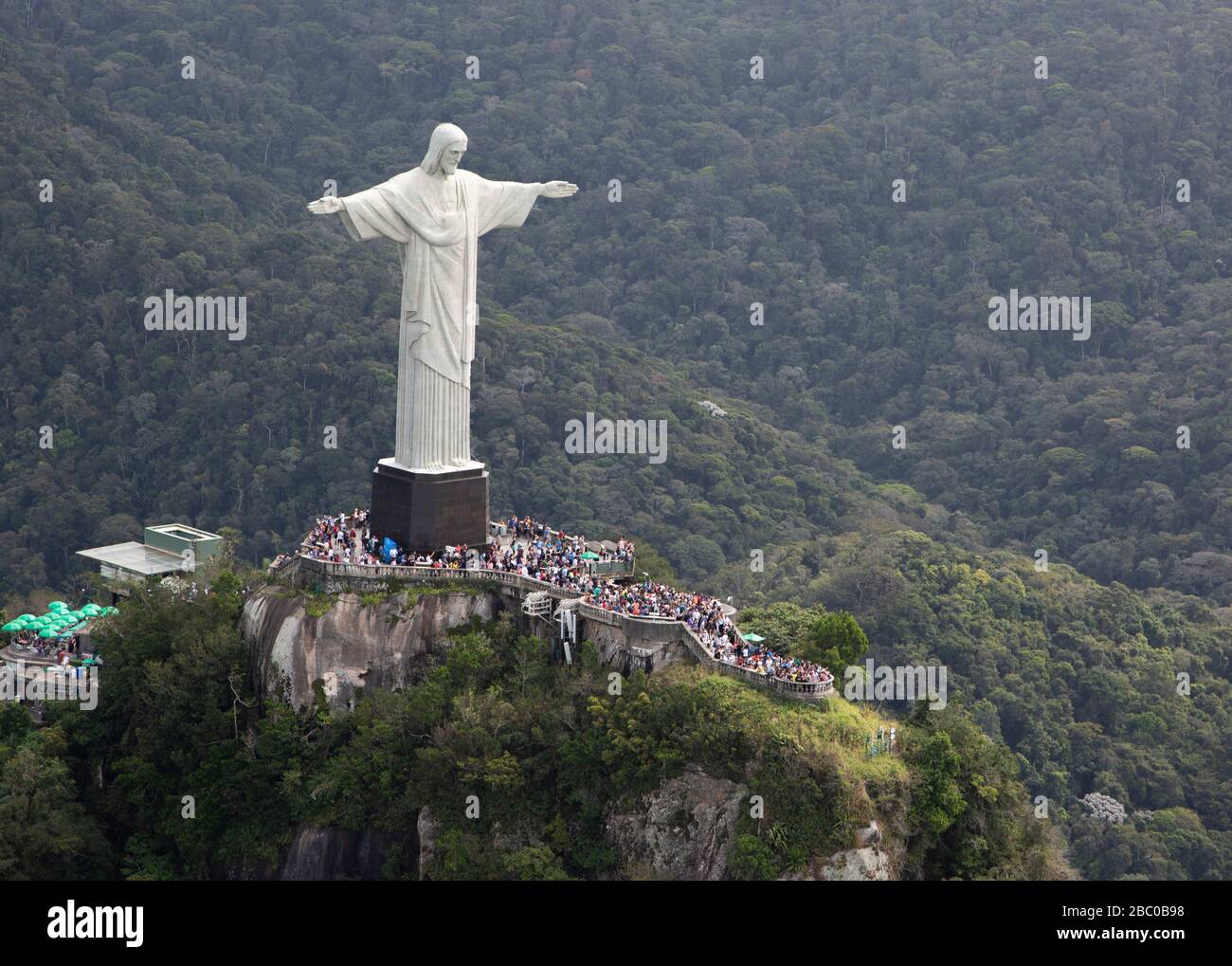 A view of Christ the Redeemer from above with a background of green tropical forest in Rio de Janeiro. Stock Photo