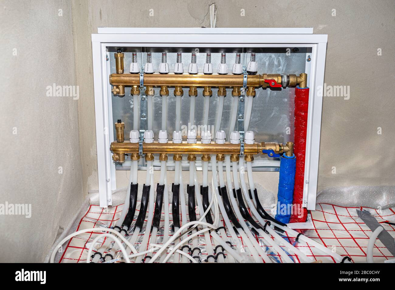 New manifold of underfloor heating system, plastic pipes and valves