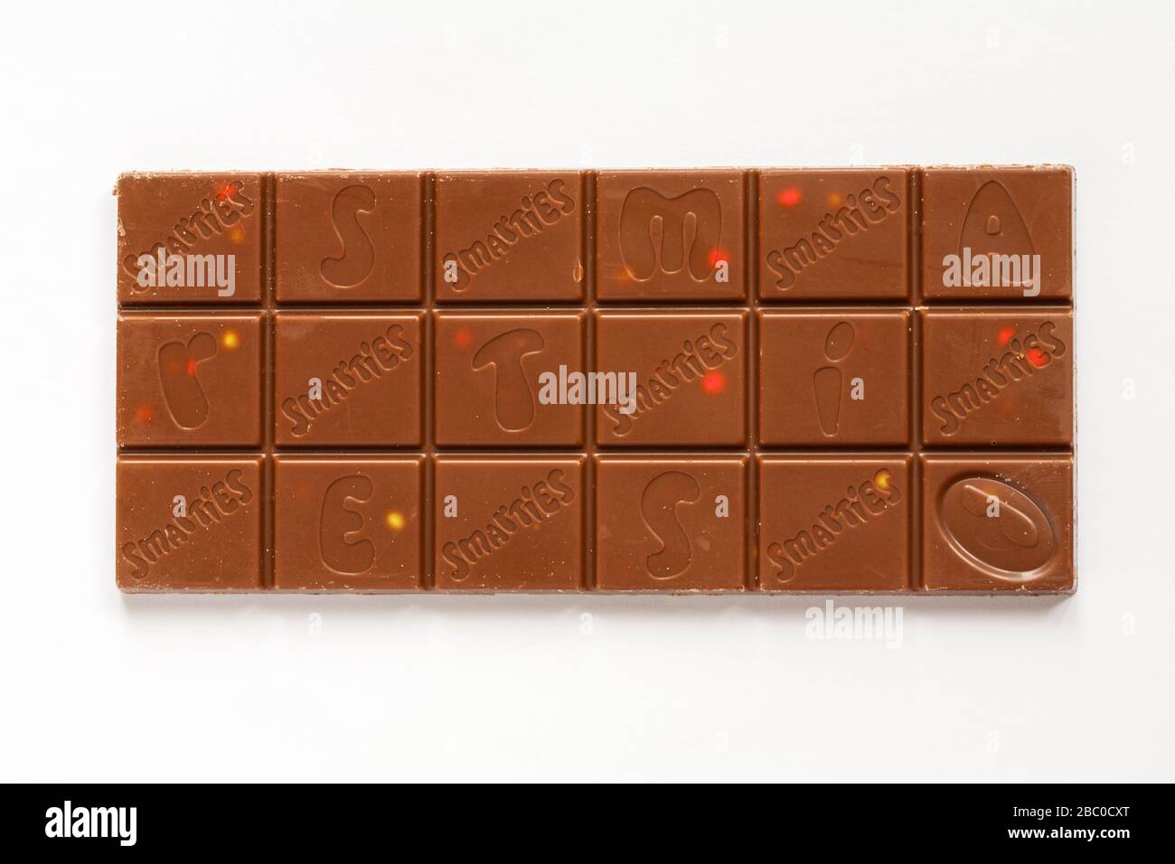 Bar of Nestle Smarties Festive Sharing Block of chocolate out of wrapper showing chocolate squares isolated on white background Stock Photo