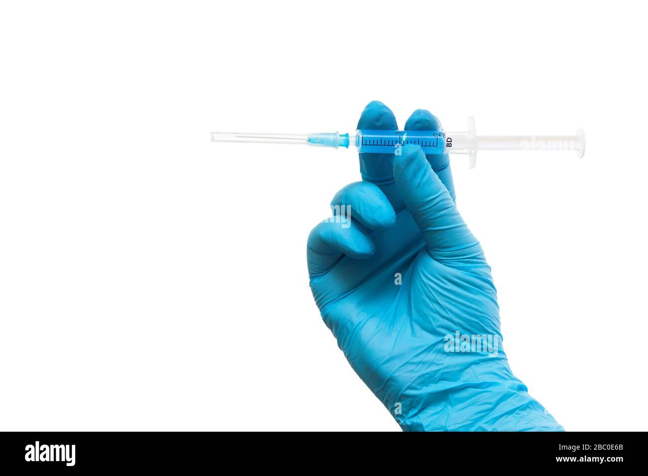 Medics defeated coronavirus. Concept. Hand in a medical glove with a red label of coronavirus Stock Photo