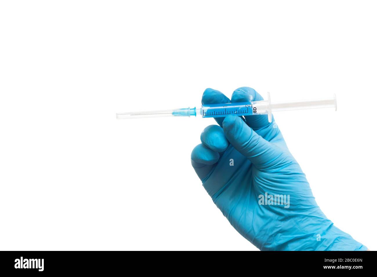 Medics defeated coronavirus. Concept. Hand in a medical glove with a red label of coronavirus Stock Photo