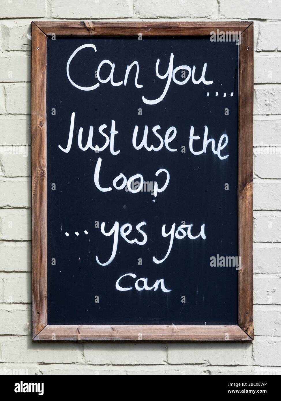 Comical toilet sign 'Can you just use the loo? . . . Yes you can' outside a pub in Ironbridge, Shropshire, UK Stock Photo