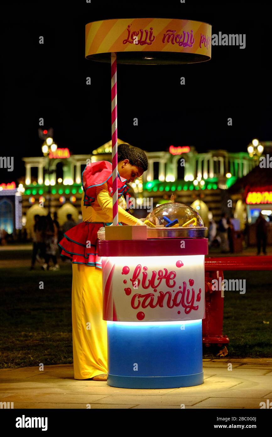 Candy seller at Global Village, Dubai, UAE. Global Village combines cultures of 90 countries across the world in one place. Stock Photo