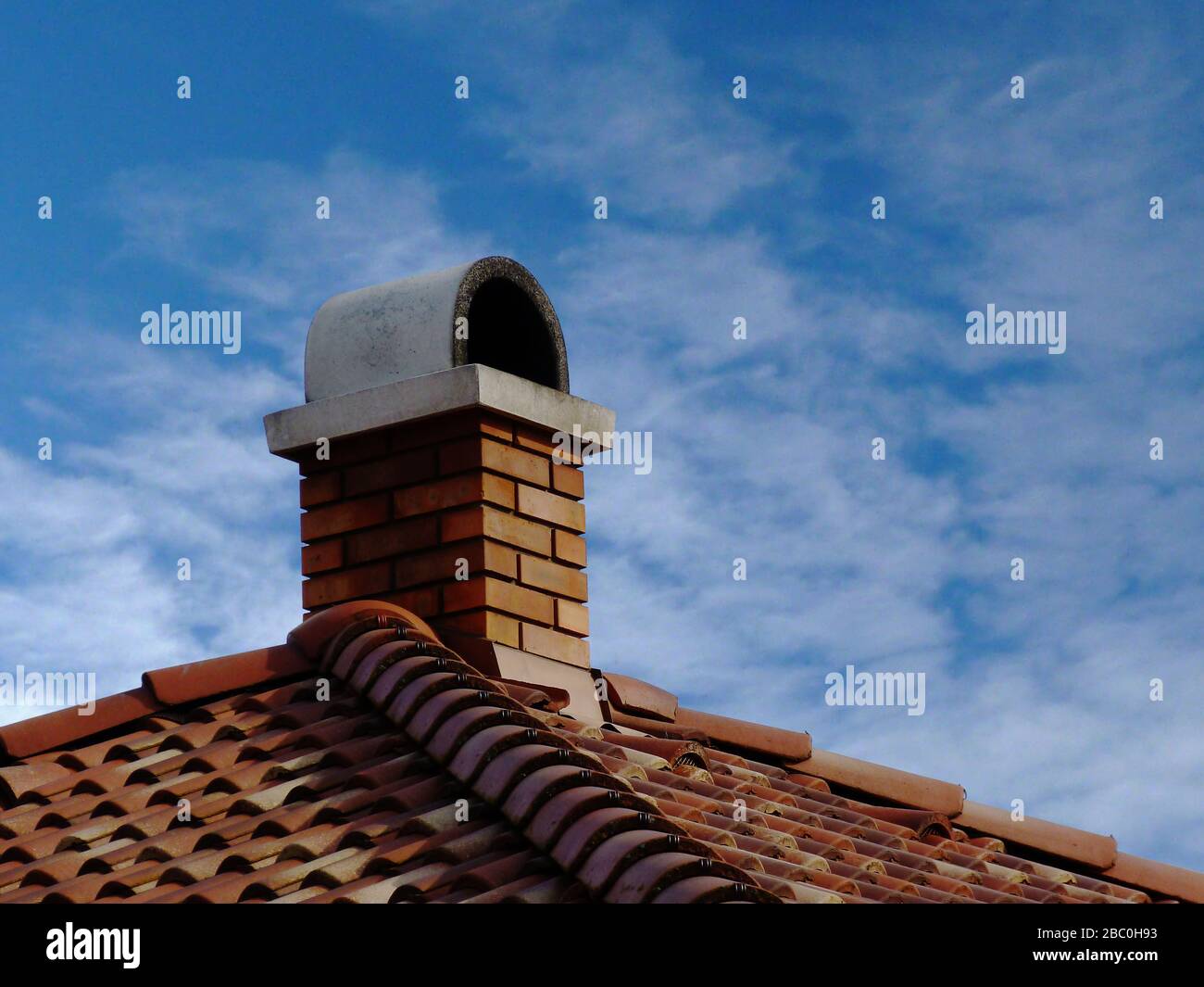 brick chimneys. gray arched concrete cap stone. metal flashing. red