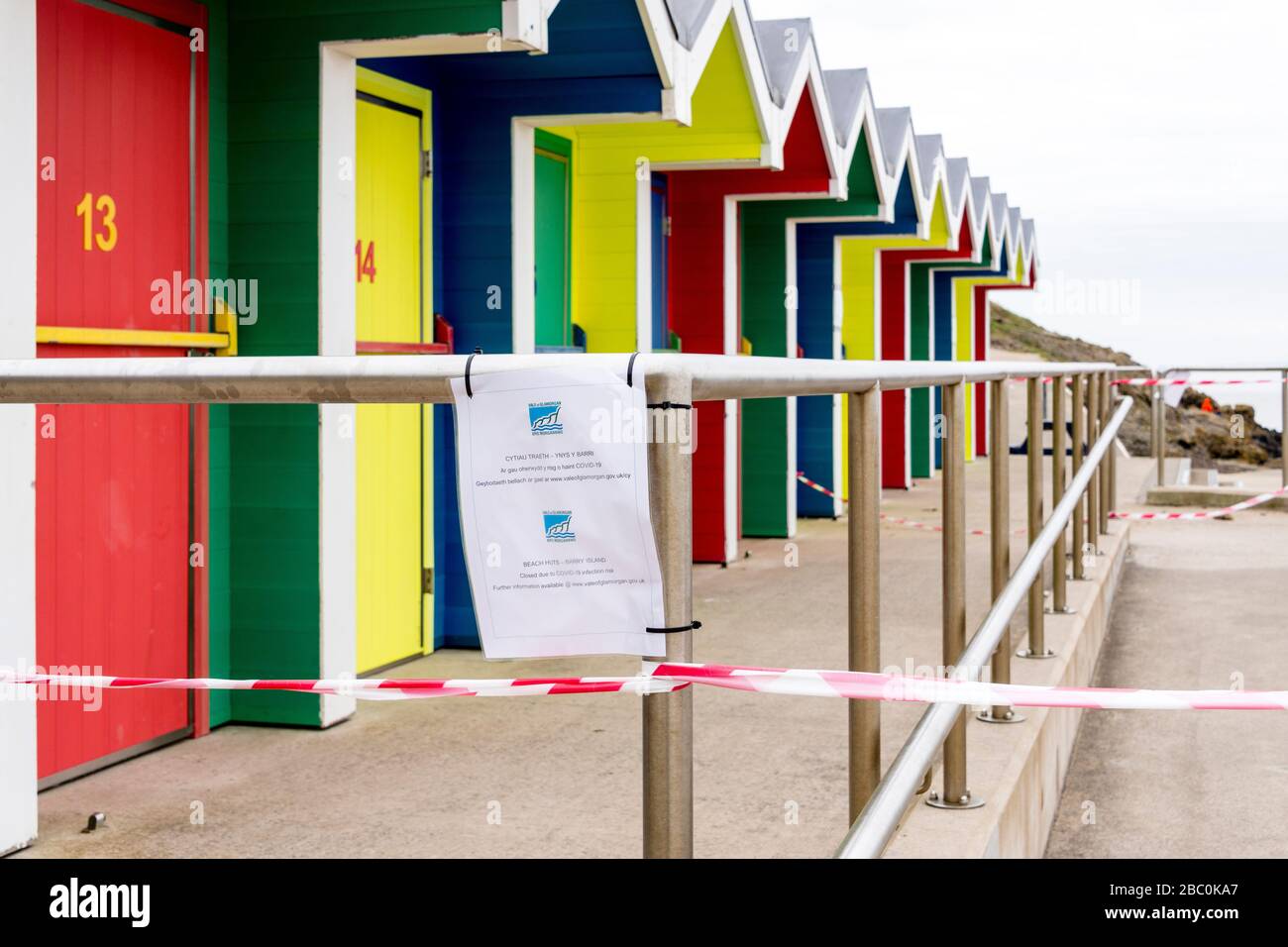 Beach huts at Barry Island are taped off and a council notice prohibits access during the Covid-19 crises. Stock Photo