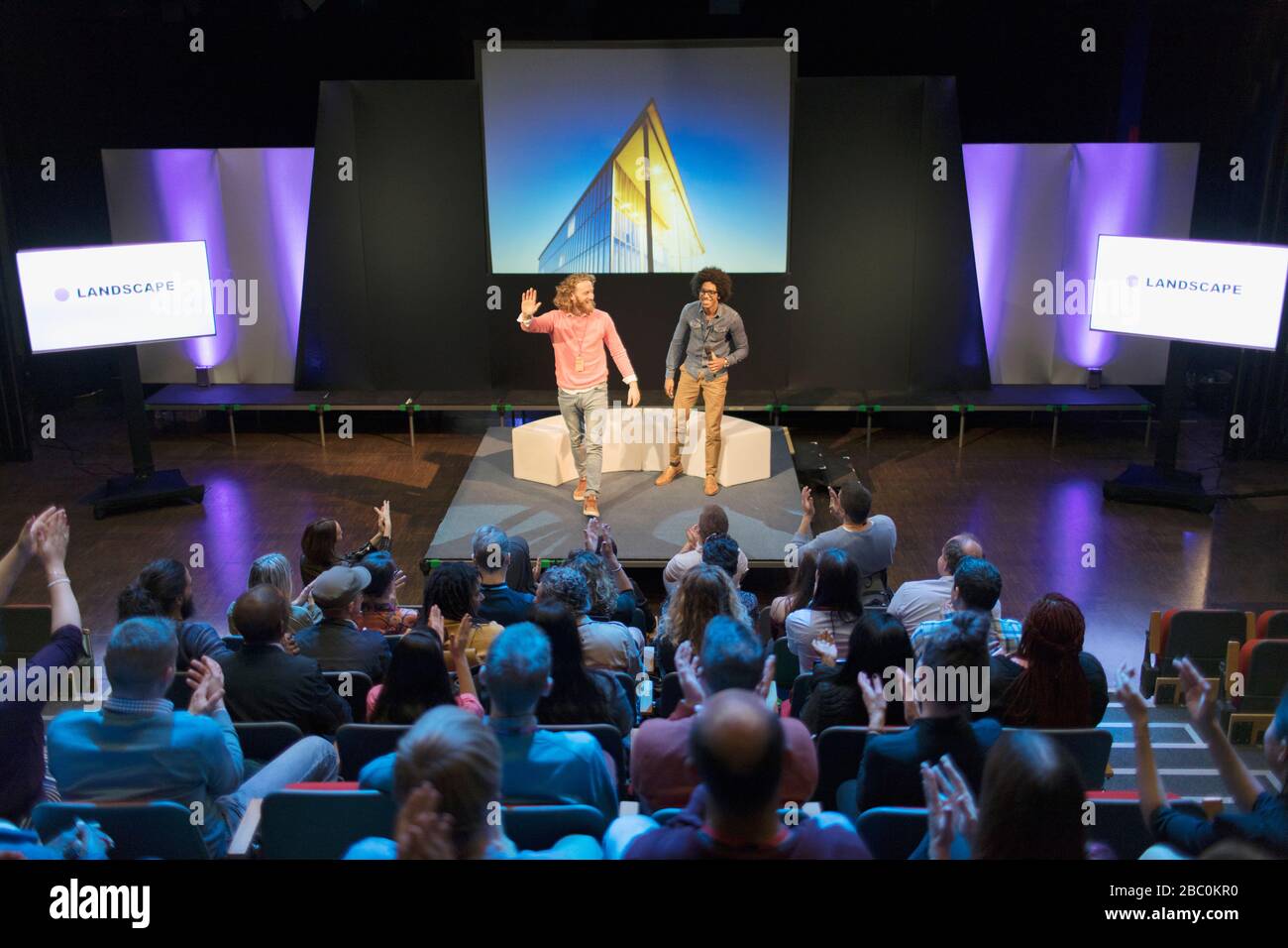 Audience clapping for photographers on stage Stock Photo