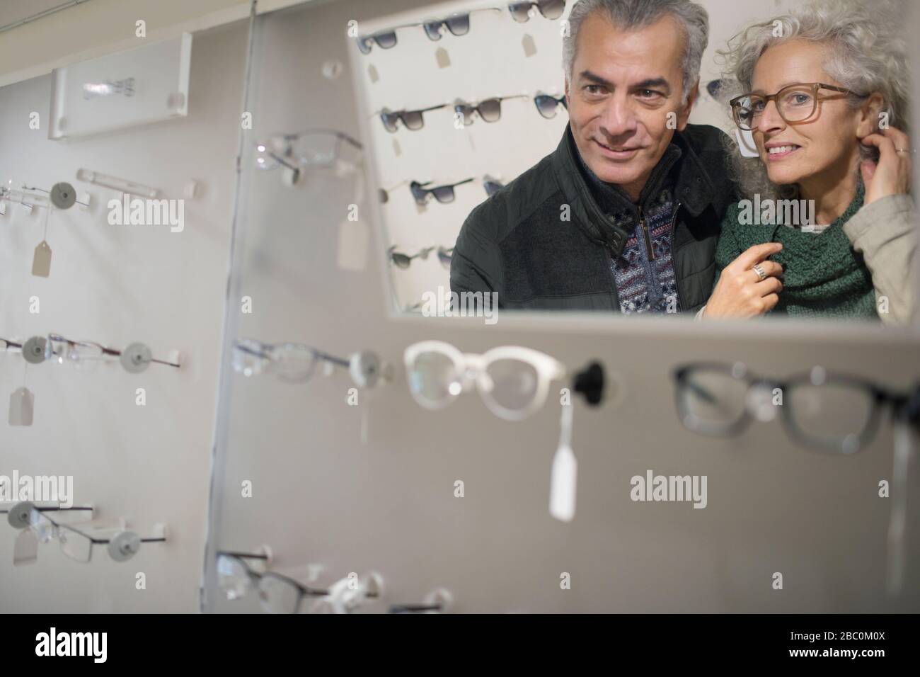 Senior couple shopping for eyeglasses in optometry shop Stock Photo