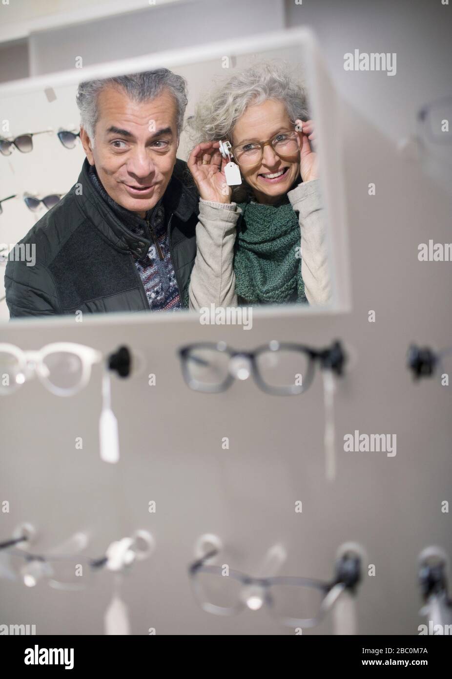 Senior couple shopping for eyeglasses in optometry shop Stock Photo