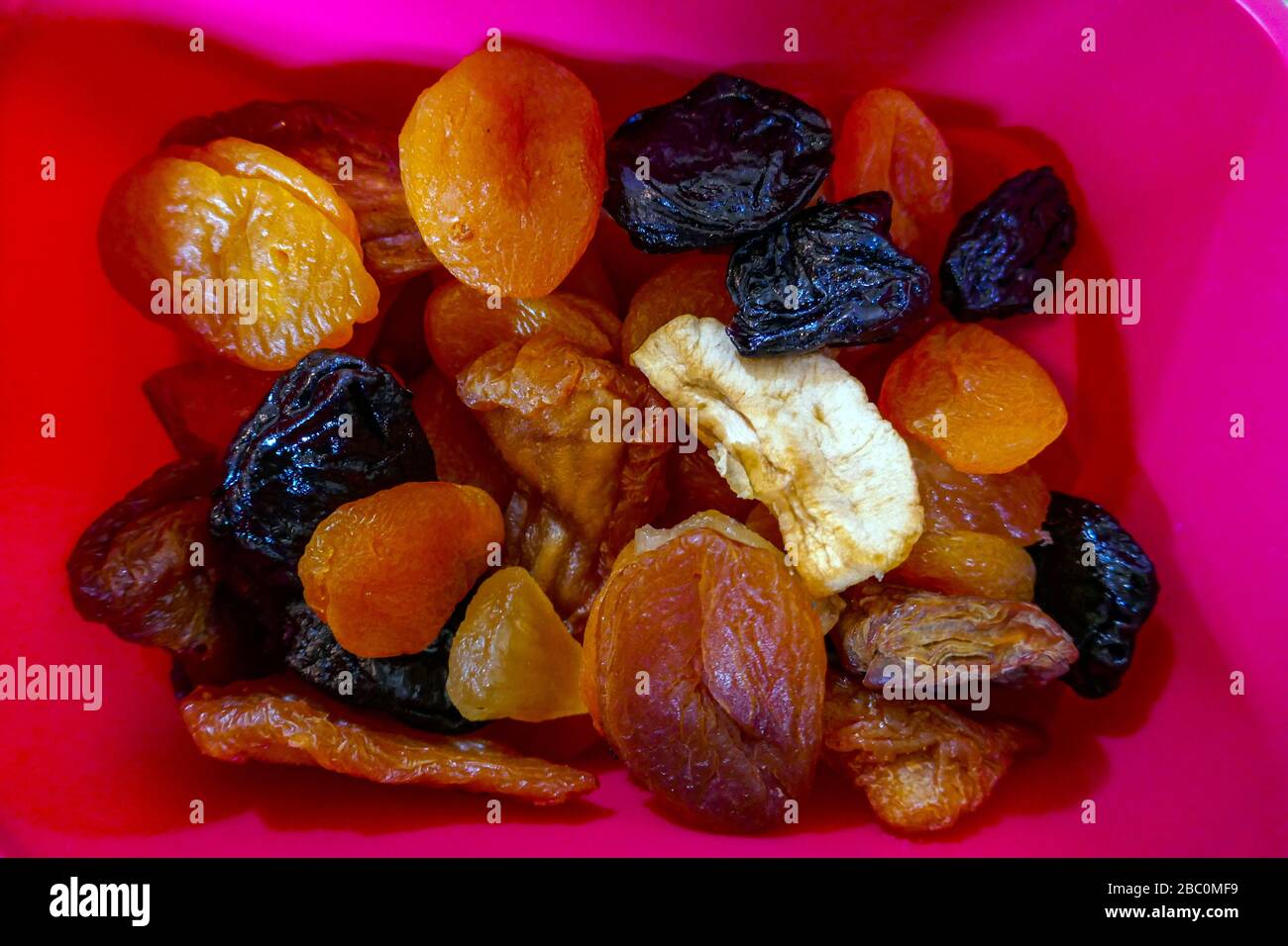 Various dried fruit in pink plastic box, Ornolac, Ussat les Bains, Ariege, French Pyrenees, France Stock Photo