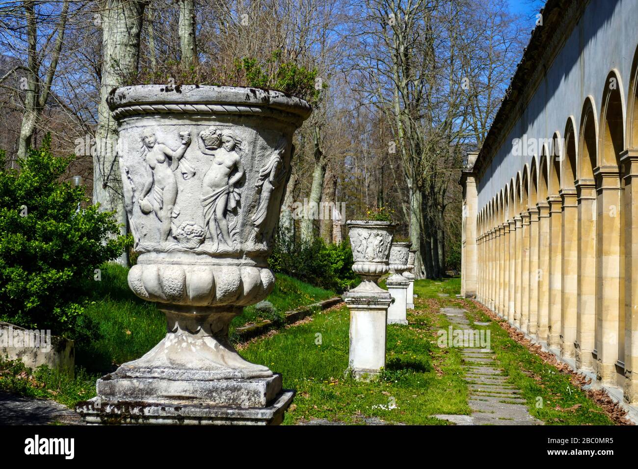 Concrete flower urn and geometric arches of thermal spa, at Ornolac, Ussat les Bains, Ariege, French Pyrenees, France Stock Photo