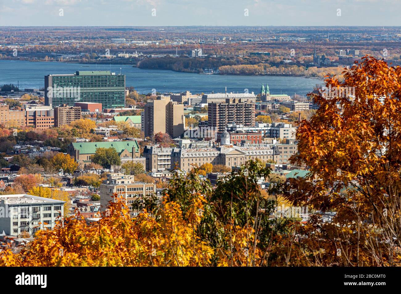 AUTUMN COLORS IN MONT-ROYAL PARK AND VIEW OF THE SAINT LAWRENCE RIVER AND THE CITY OF MONTREAL, QUEBEC, CANADA Stock Photo