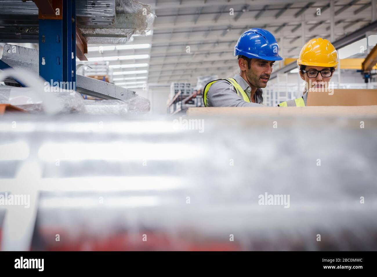 Managers using laptop in factory Stock Photo