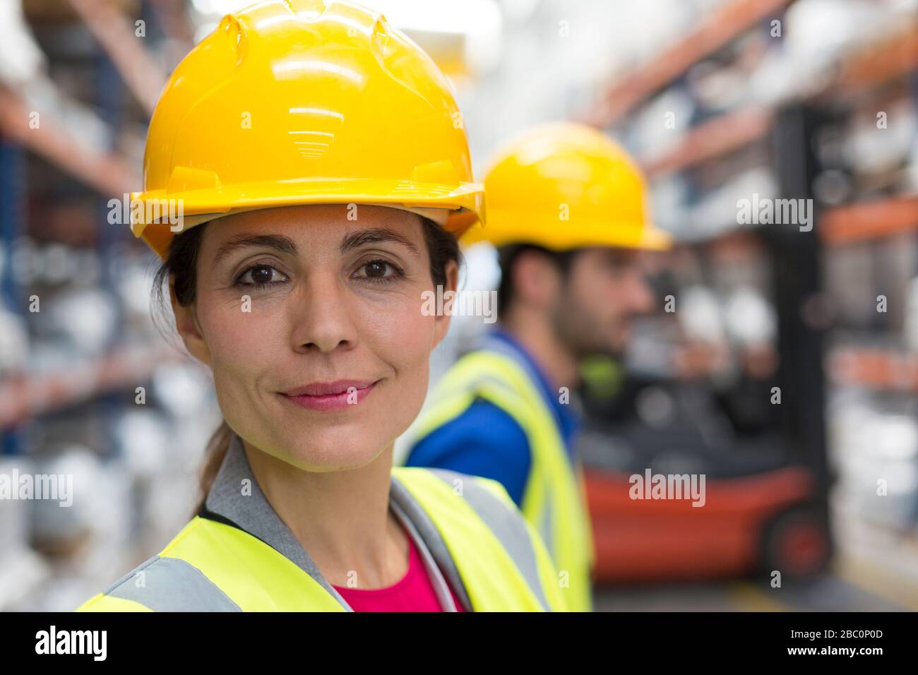 Portrait confident female worker in warehouse Stock Photo