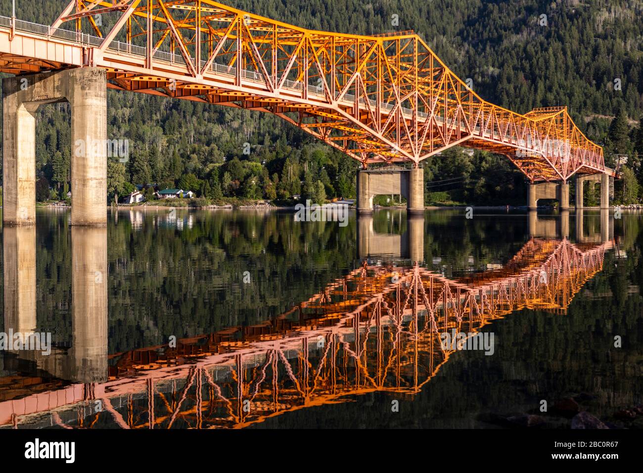 The distinctive Big Orange Bridge, or just BOB, is the only crossing of the Kootenay River into the mountain town of Nelson, British Columbia, Canada Stock Photo