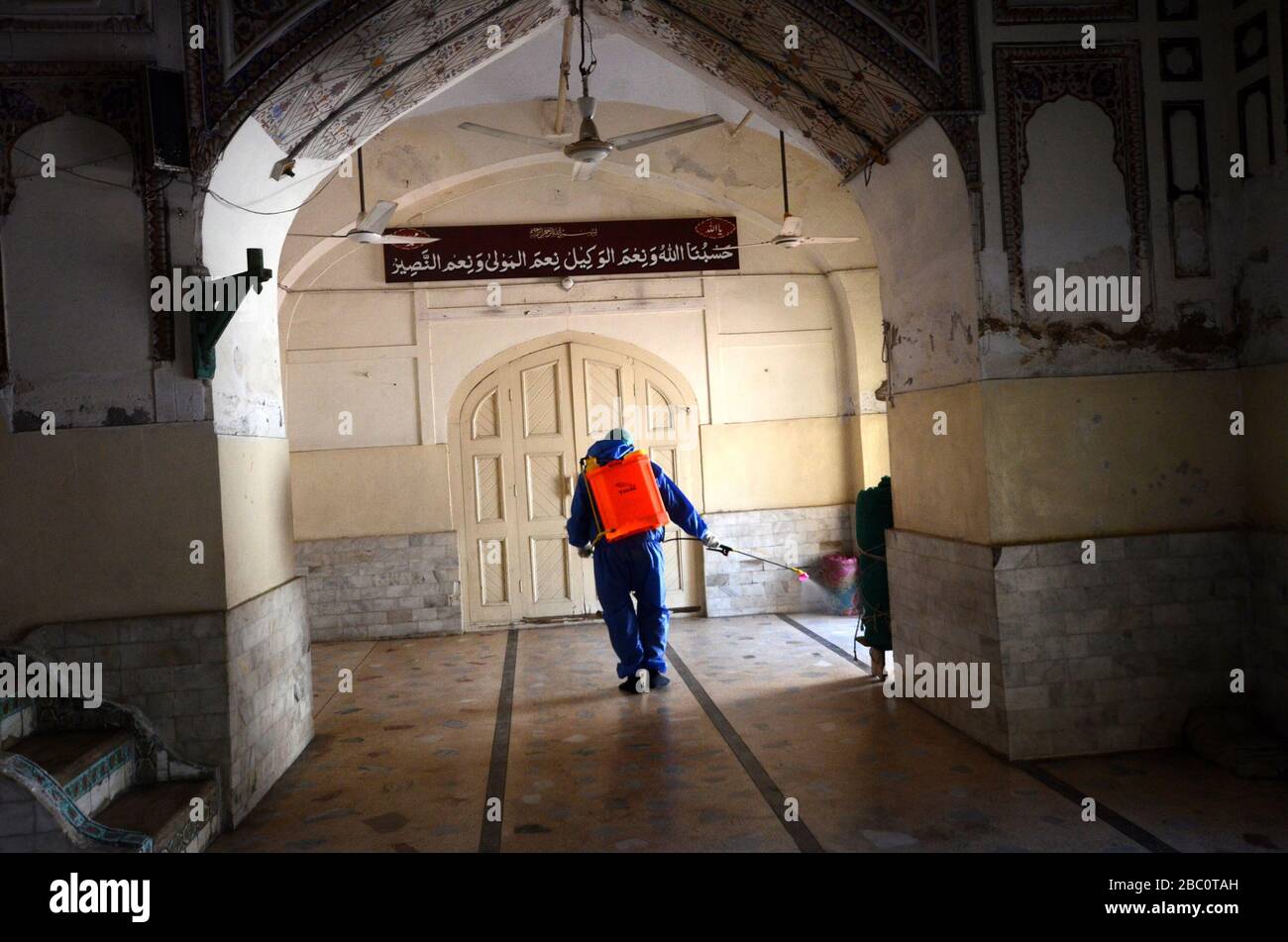 Municipal corporation team members spray disinfectant to sanitize the surroundings of the Dilawar Khan Mosque and street following an outbreak of the corona virus in the city of Peshawar, Pakistan on April 2, 2020. (Photo by Hussain Ali/Pacific Press/Sipa USA) Stock Photo