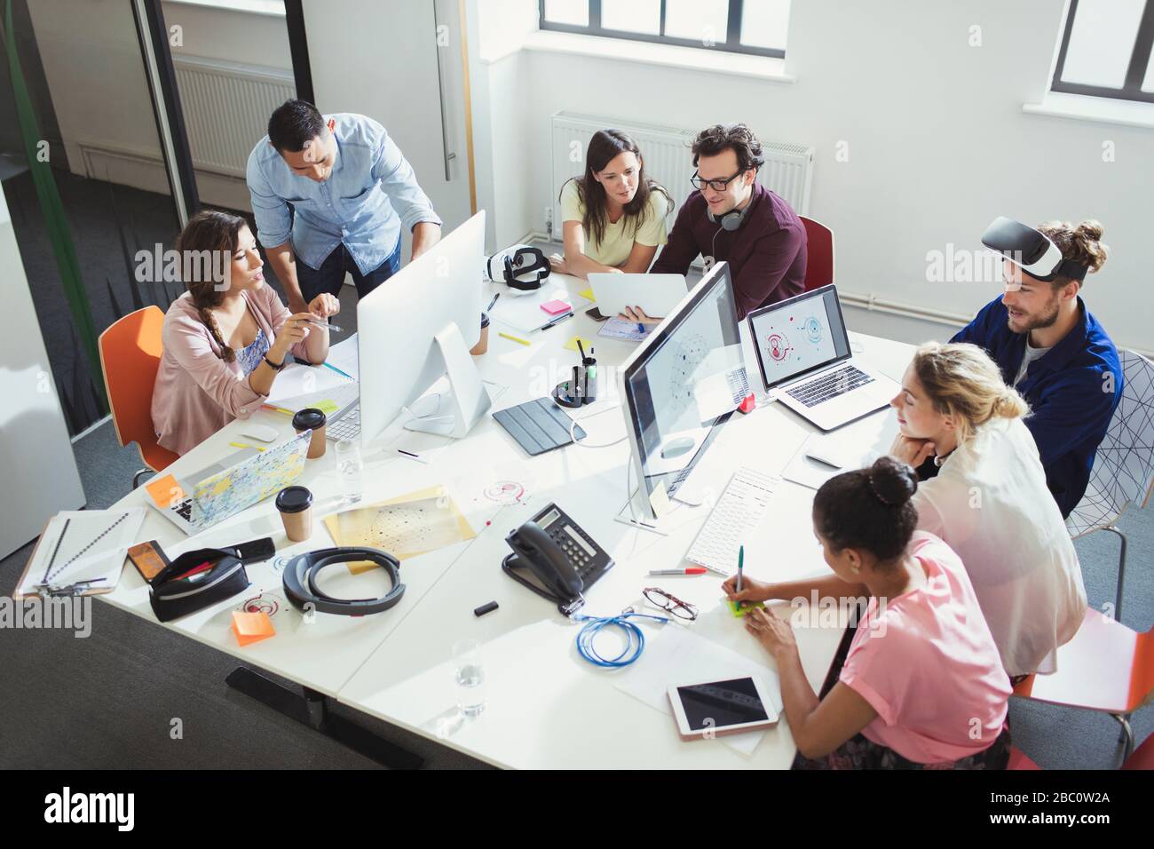 Computer programmers working in open plan office Stock Photo