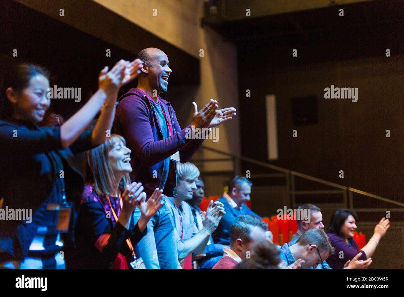 Enthusiastic audience clapping and cheering Stock Photo
