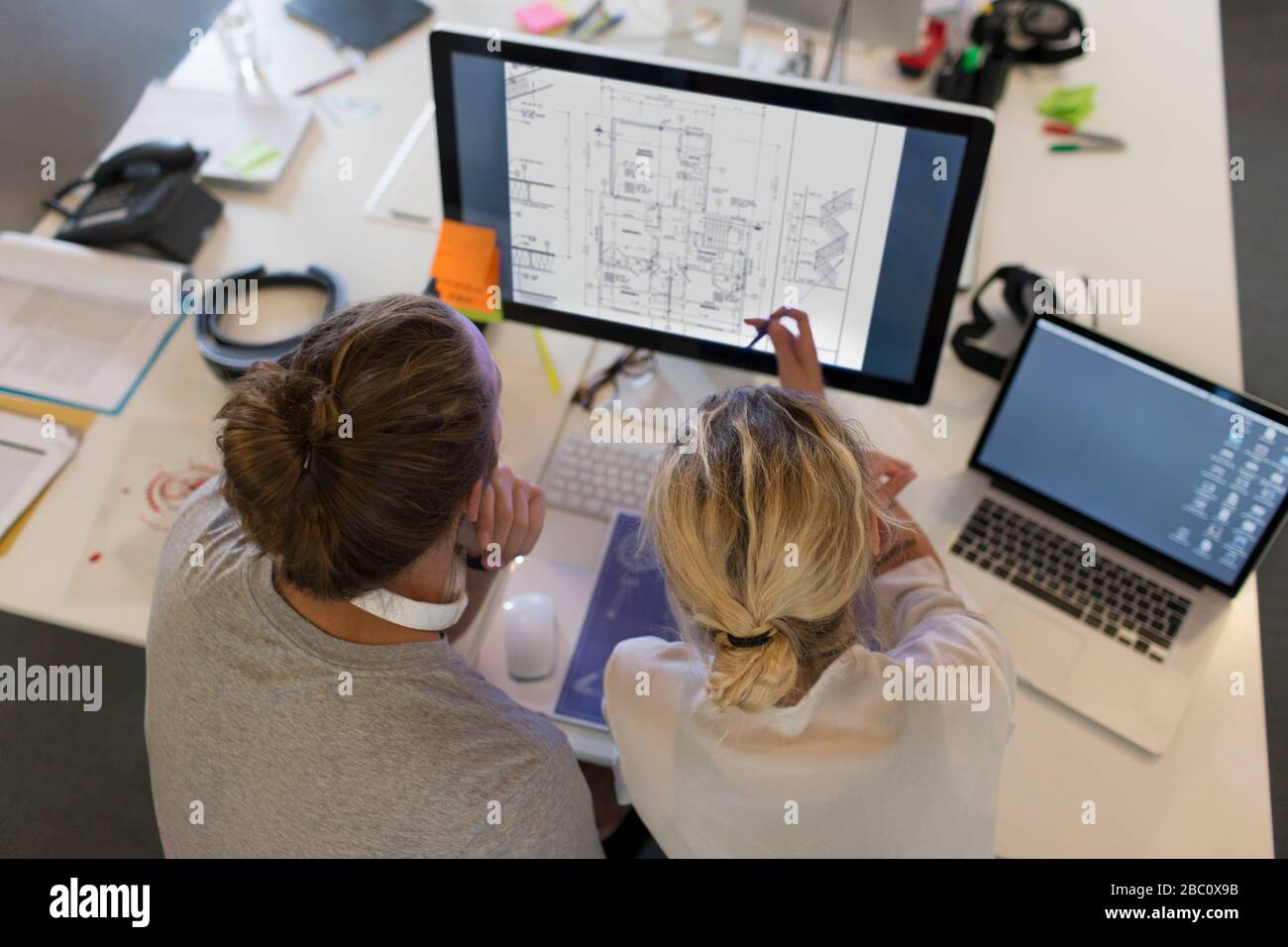 Architects meeting, viewing digital blueprints on computer Stock Photo