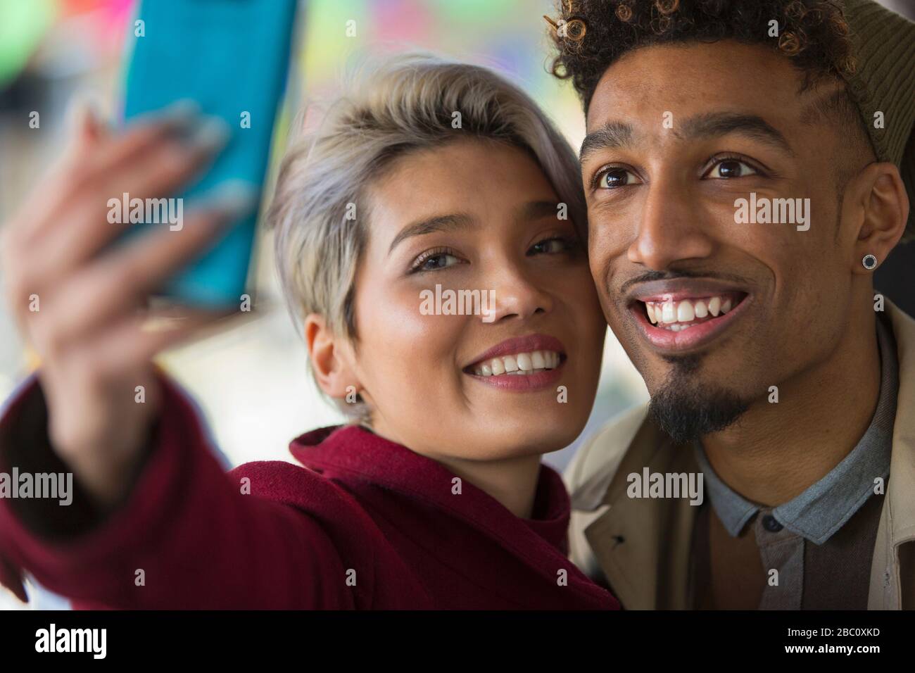 Smiling young couple taking selfie with camera phone Stock Photo