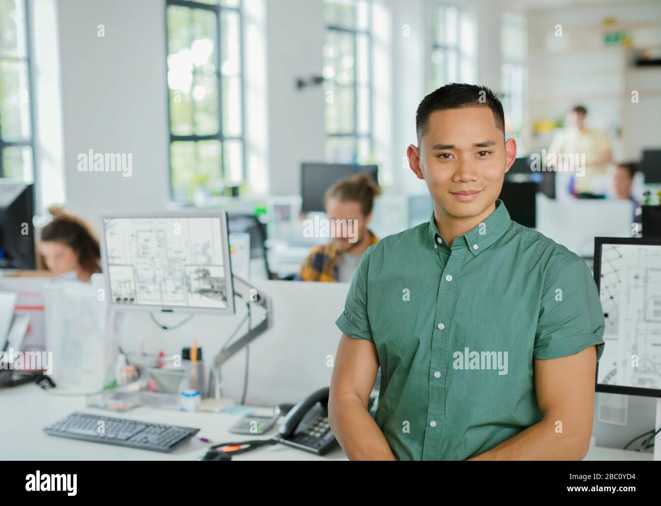 Portrait confident male architect in open plan office Stock Photo