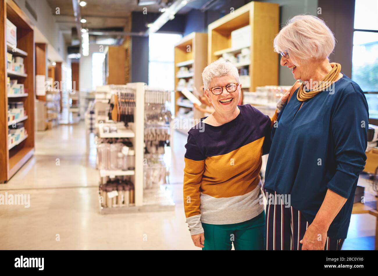 Portrait happy laughing senior women friends in home goods store Stock Photo