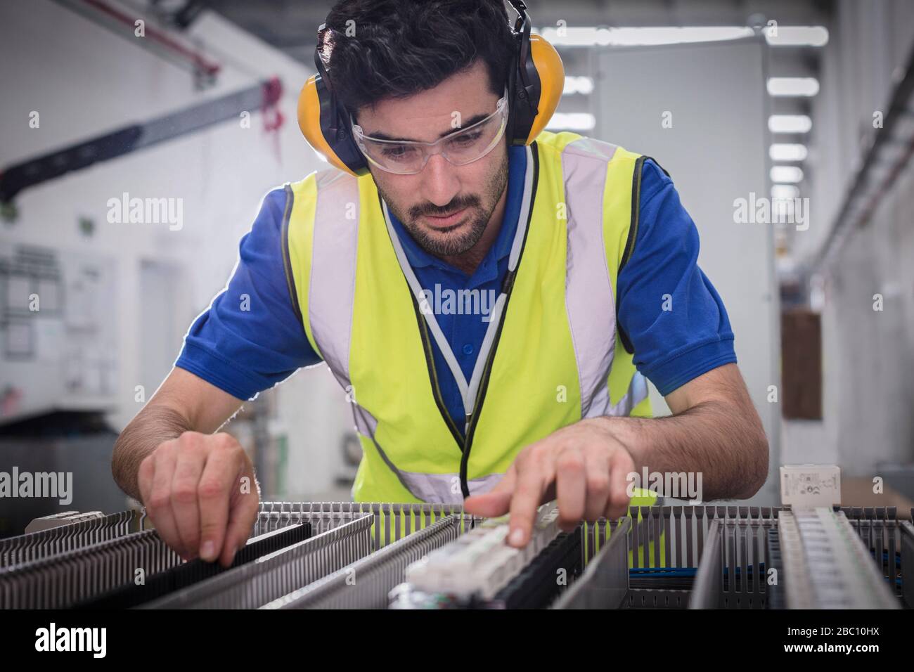 Male engineer assembling equipment in factory Stock Photo