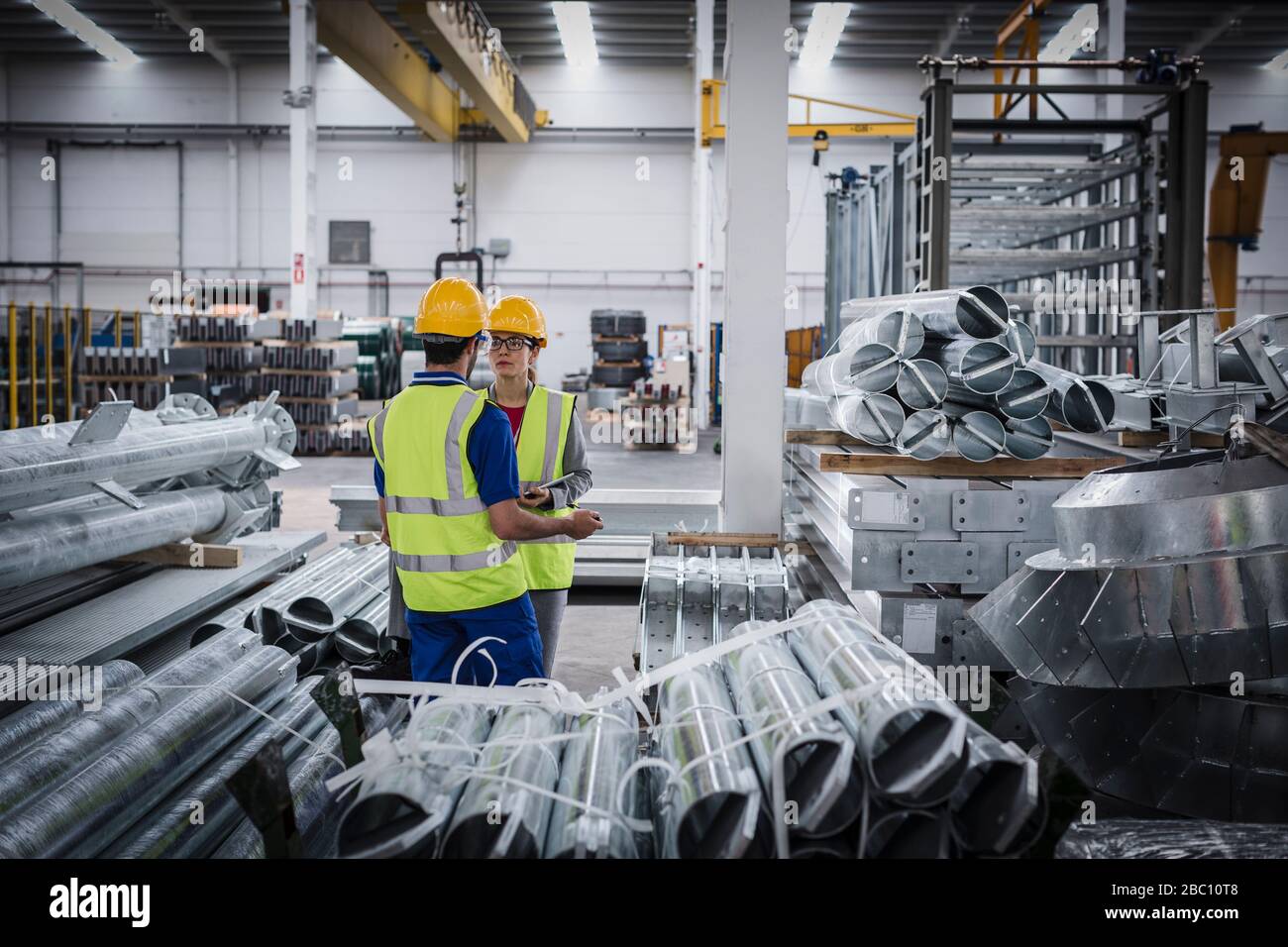 Workers talking in steel factory Stock Photo