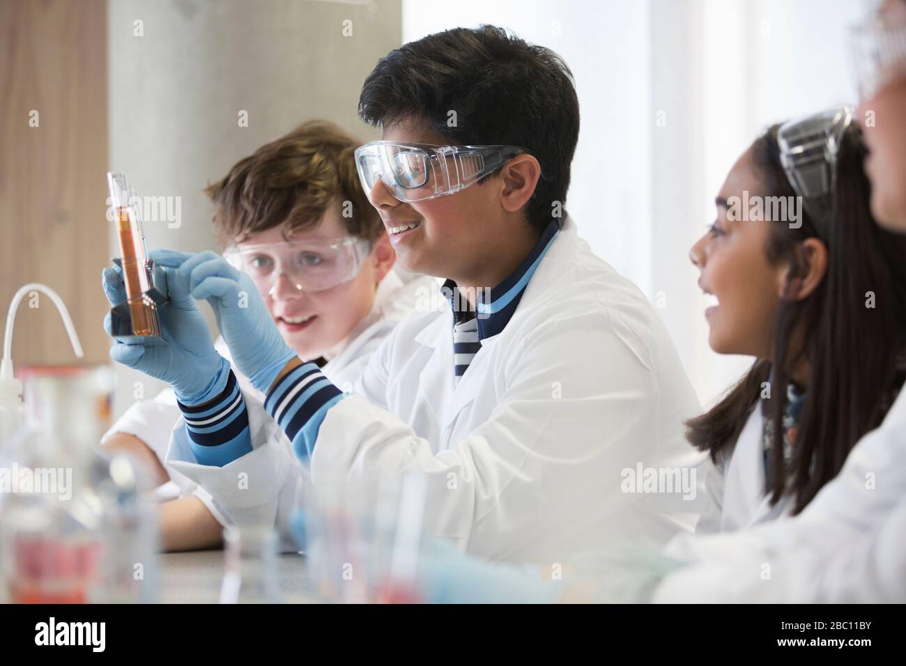 Students conducting scientific experiment in laboratory classroom Stock Photo