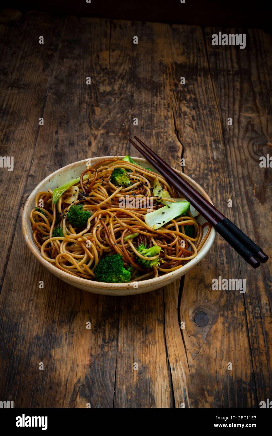 Bowl of Japanese soba noodles with bok choy, broccolies, soy sauce and