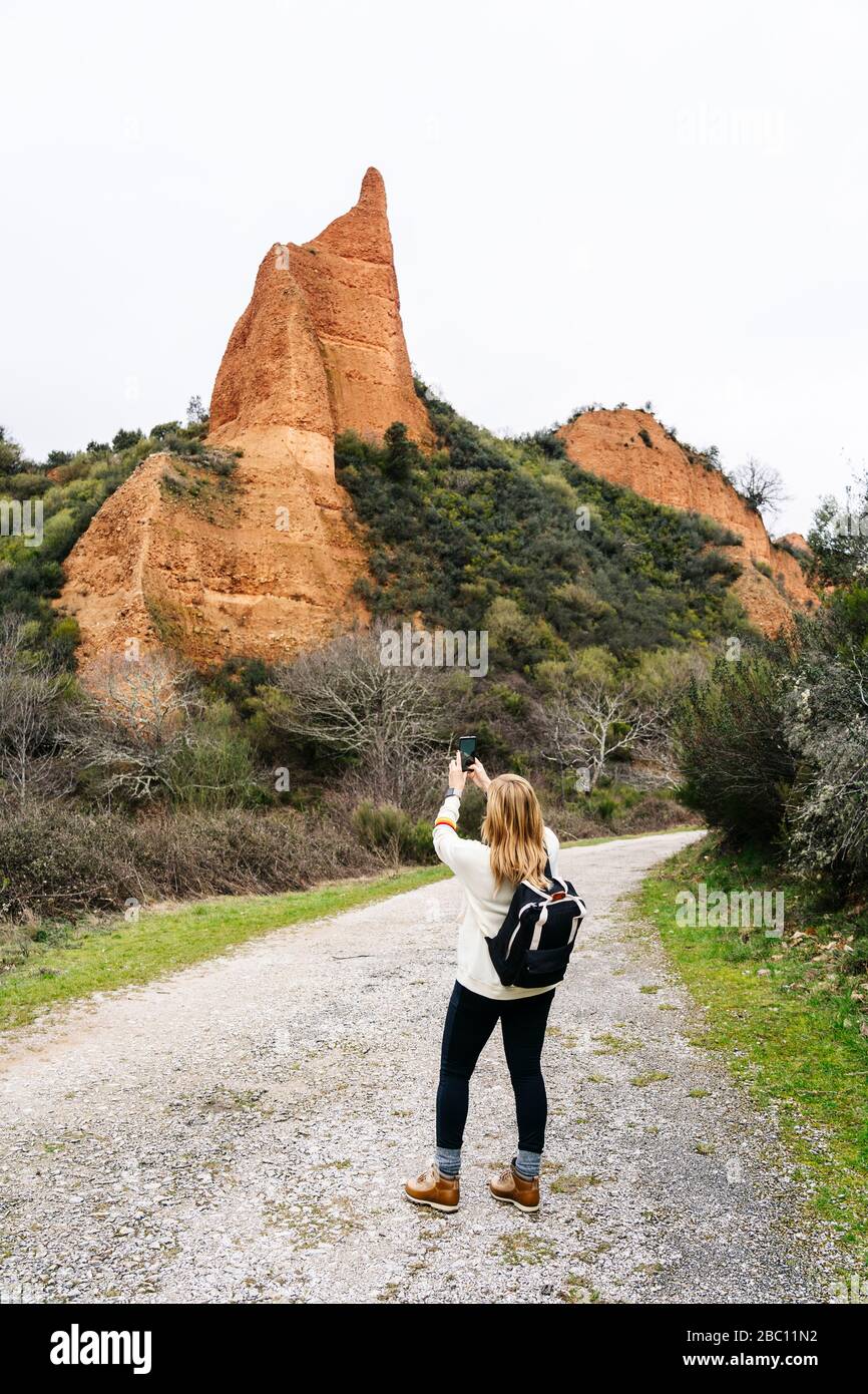 Hiker photographing Mina de Oro Romana, Las Medulas, Castile and Leon, Spain Stock Photo