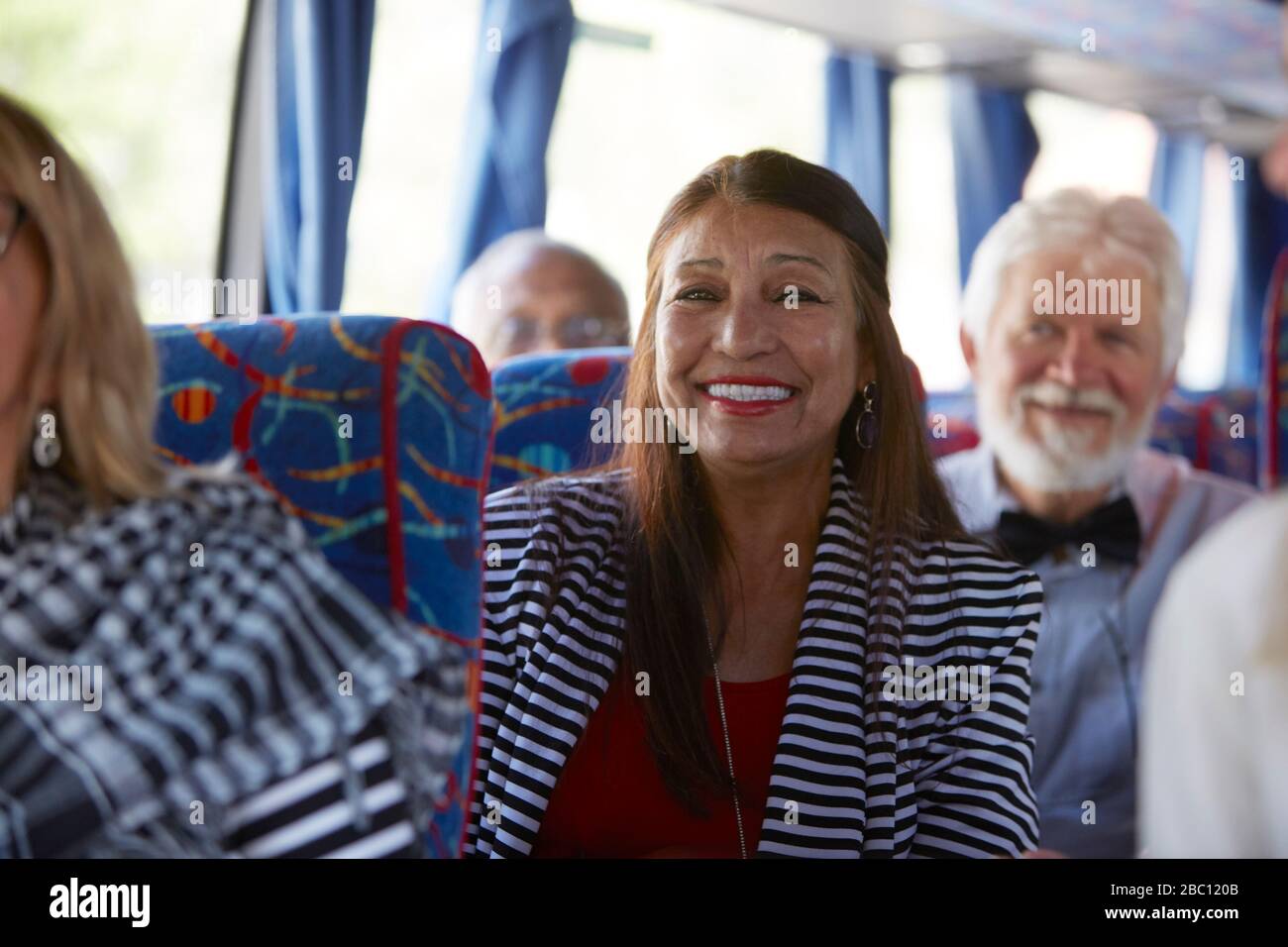 Portrait smiling, confident active senior woman tourist riding tour bus Stock Photo
