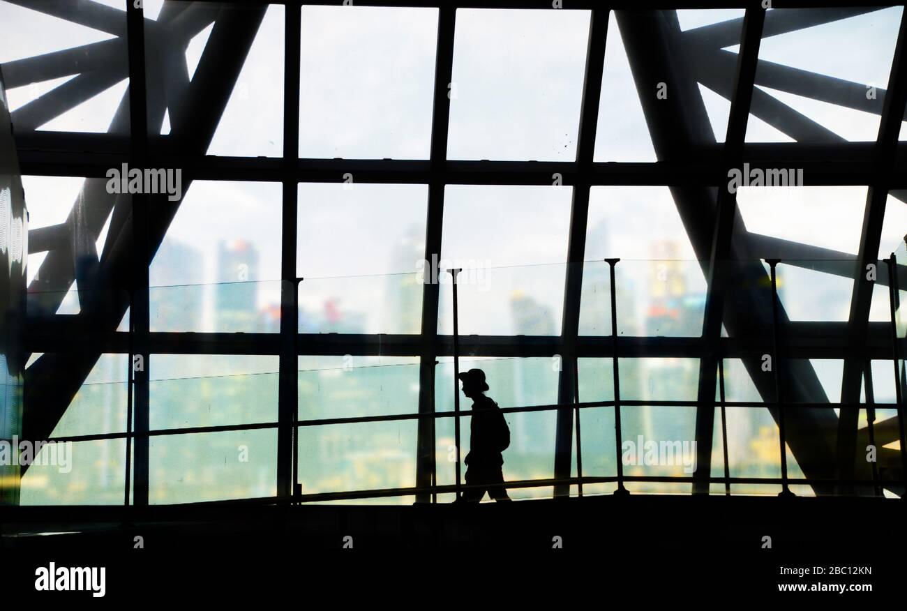 silhouette of man walking in the airport with city business background Stock Photo