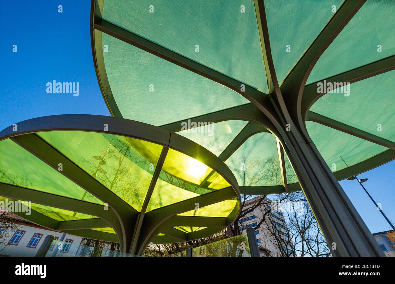 Modern roofing for the bus stop. Interesting architecture. Plastic and steel structure. Stock Photo