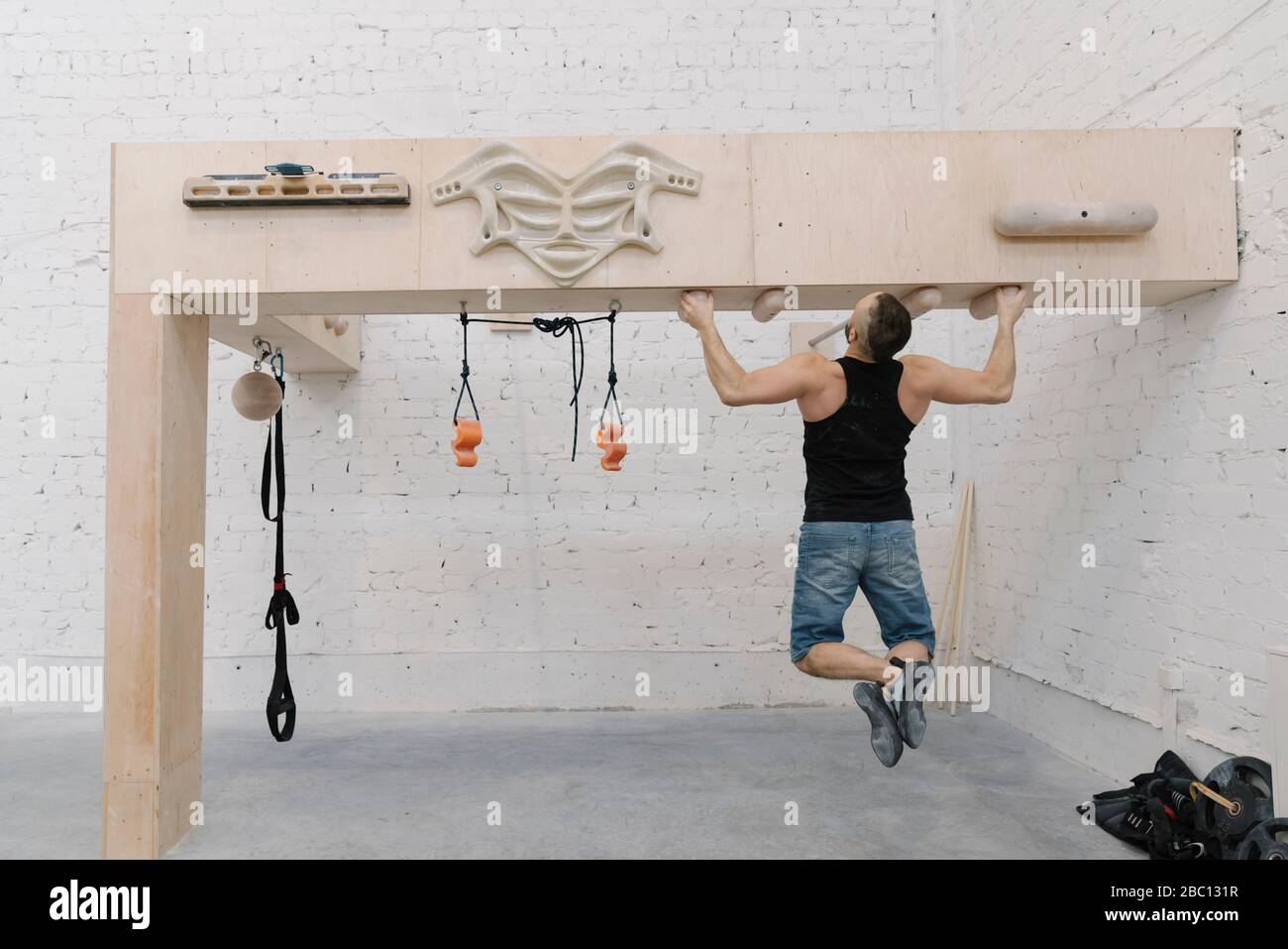 Man doing pull-ups before climbing Stock Photo