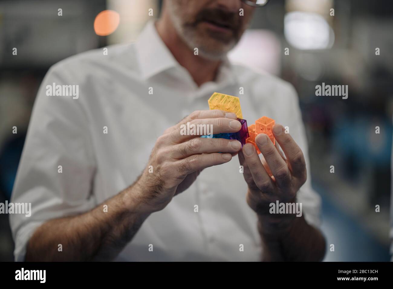 Man examining workpiece in a factory Stock Photo