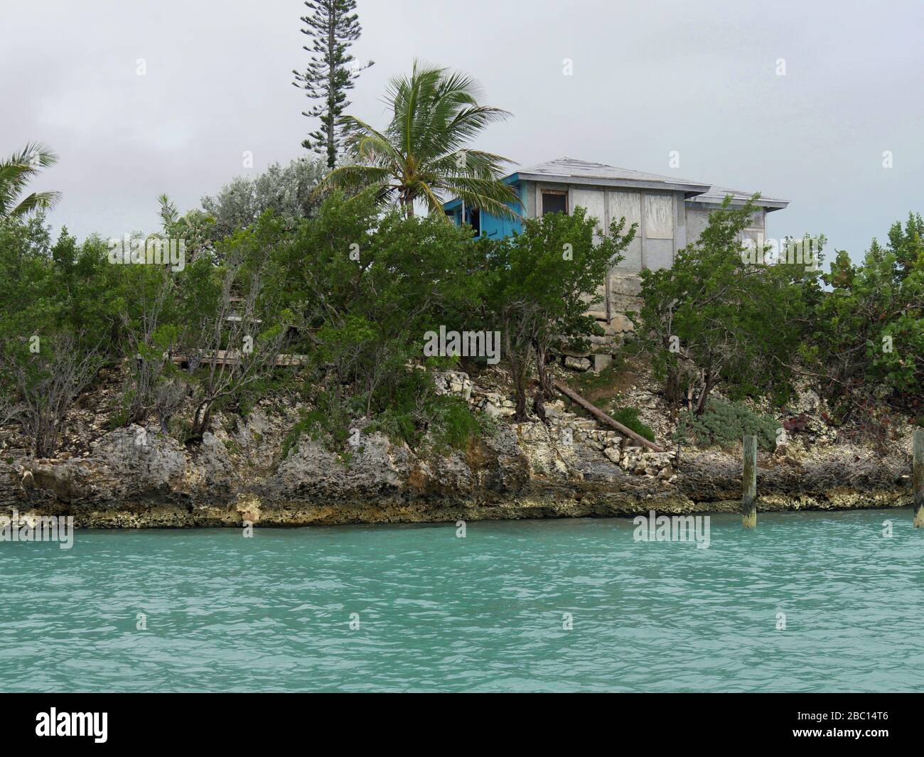 Wooden house on a rocky ledge at the Exuma Cays, Bahamas Stock Photo